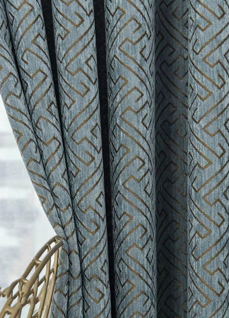 a close up of a curtain with a chair in front of it