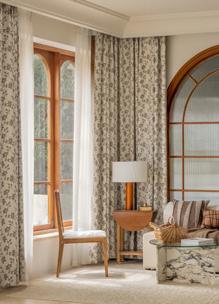 a living room filled with furniture and a large window