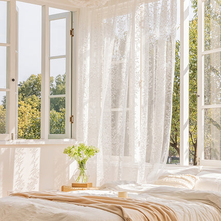 a bed sitting under a window next to a window sill