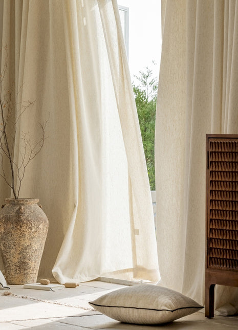a vase sitting on top of a table next to a window