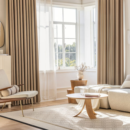 a living room filled with furniture and a large window