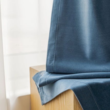 a close up of a blue curtain on a window sill