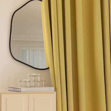 a mirror on a wall next to a dresser