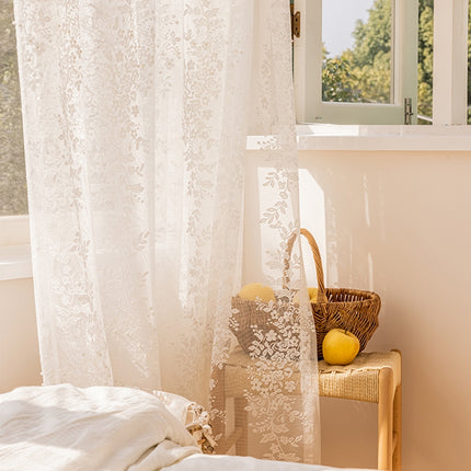 a bedroom with a white bed and a window