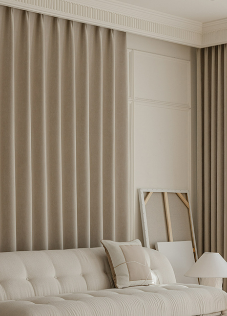 a cozy living room with a white sofa, a lamp, and a painting on the wall.