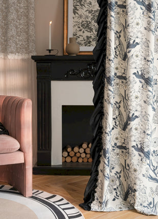 a living room with a pink chair and a fireplace