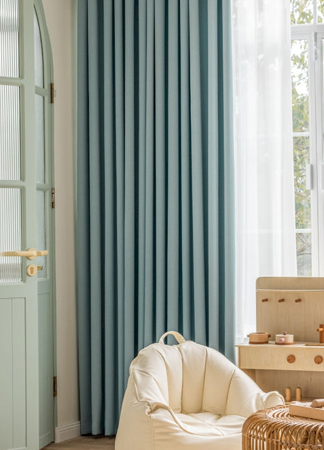 a living room filled with furniture and a large window