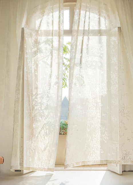 a living room with a chair and a window