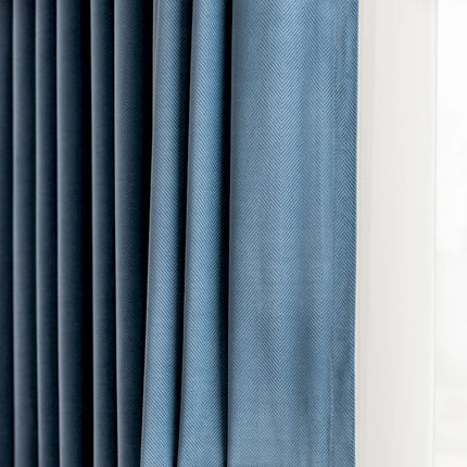 a close up of a curtain with a blue background