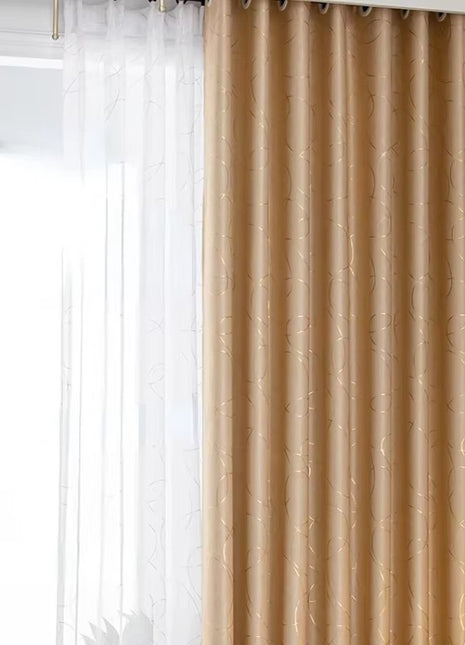 a living room with a large window covered in curtains