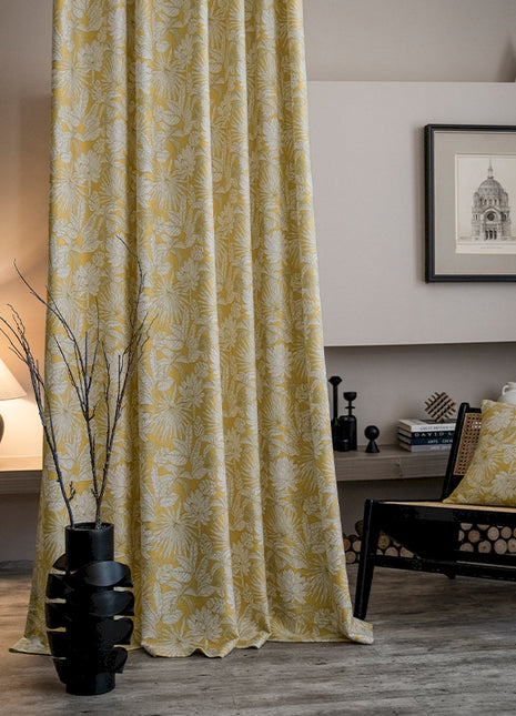 a living room with a chair and a curtain