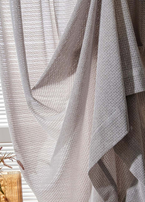 a vase with a plant in it sitting next to a window