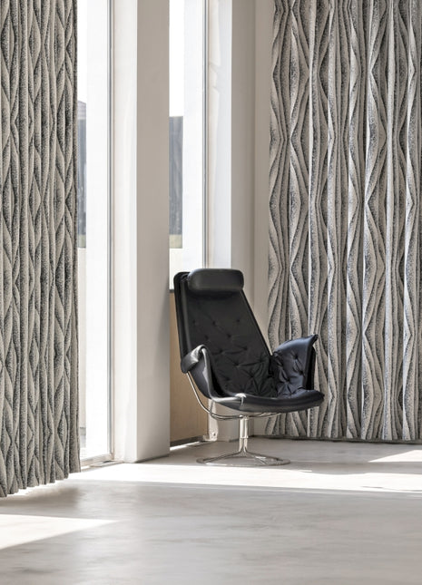 a black chair sitting in front of a window